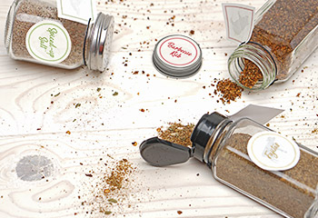 open spice jars with spices on table